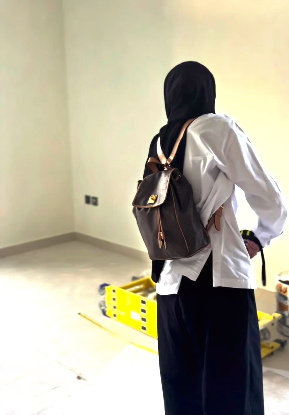Your designer on site, tape measure in hand, in an empty flat